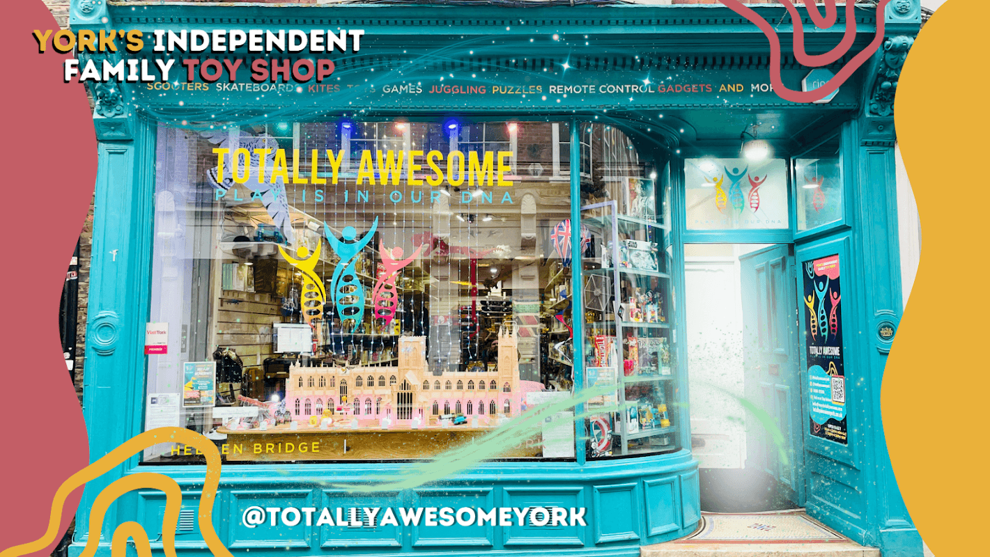 Colorful storefront of Totally Awesome York, showcasing toys, games, and vibrant decorations in a charming shopfront.