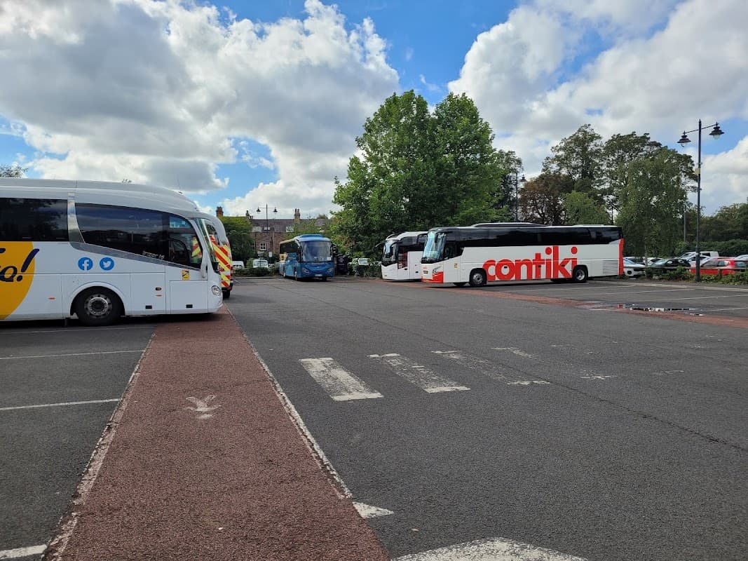 Buses parked in Union Terrace Coach Park, with trees and cloudy sky in the background. Pay & Display signage visible.