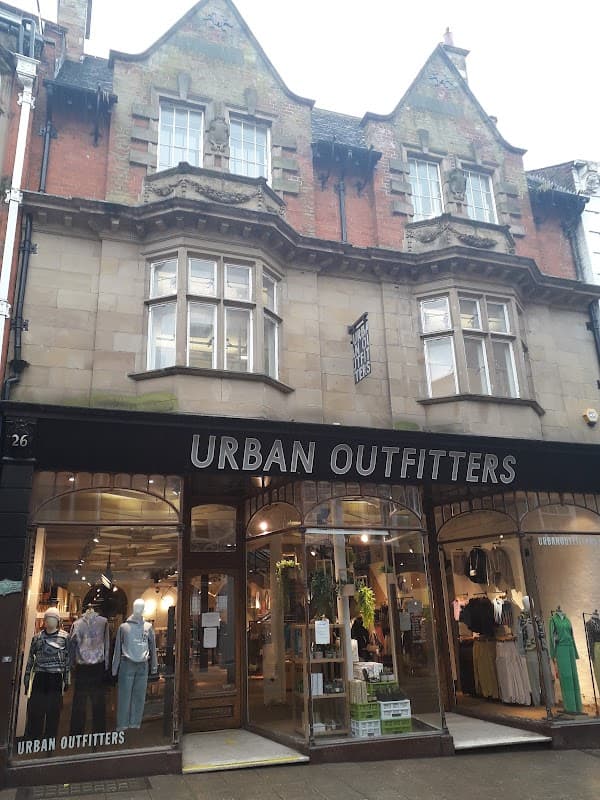 Urban Outfitters storefront with large windows, displaying clothing and accessories, in a historic building in York.