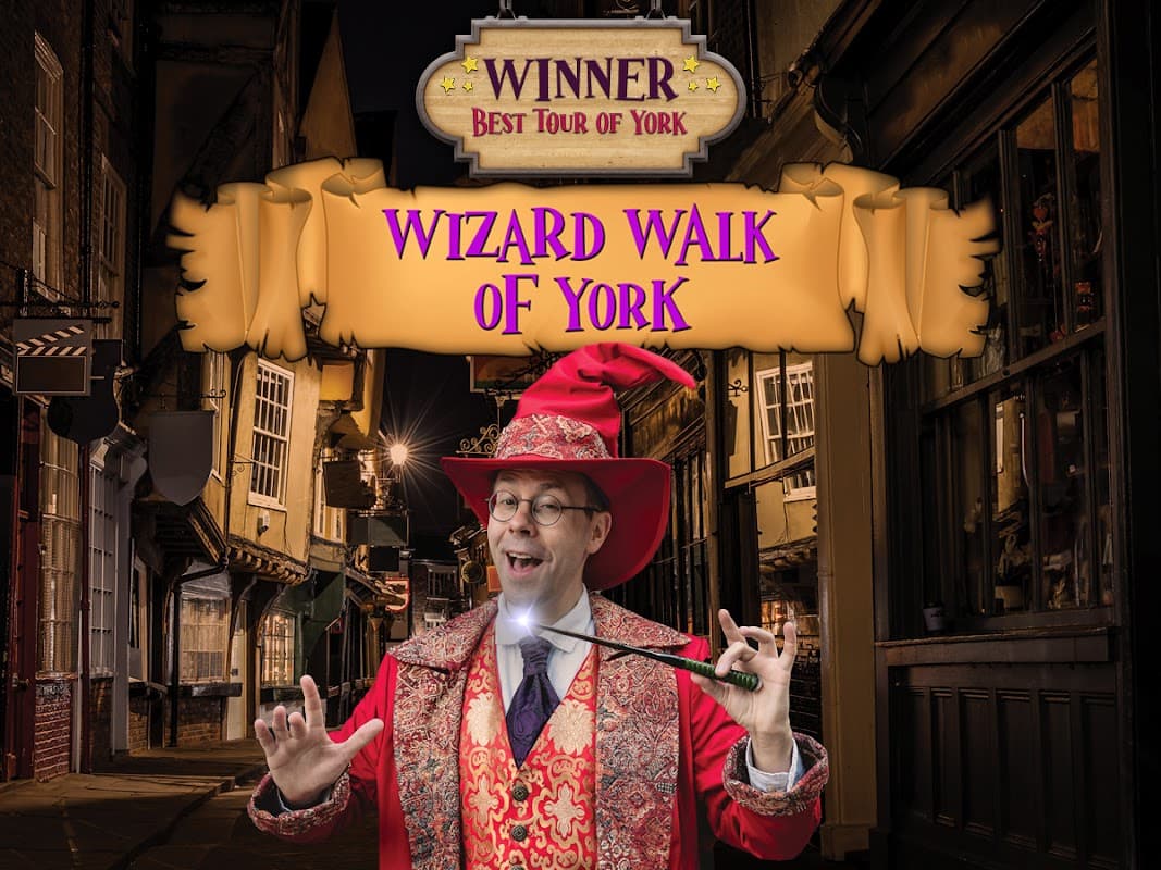Wizard Walk of York award banner with a wizard in a red hat and robe, holding a wand in a historic street setting.