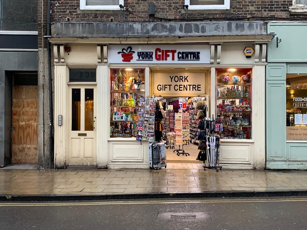 Storefront of York Gift Centre with colorful merchandise displays and a welcoming entrance on a rainy street.