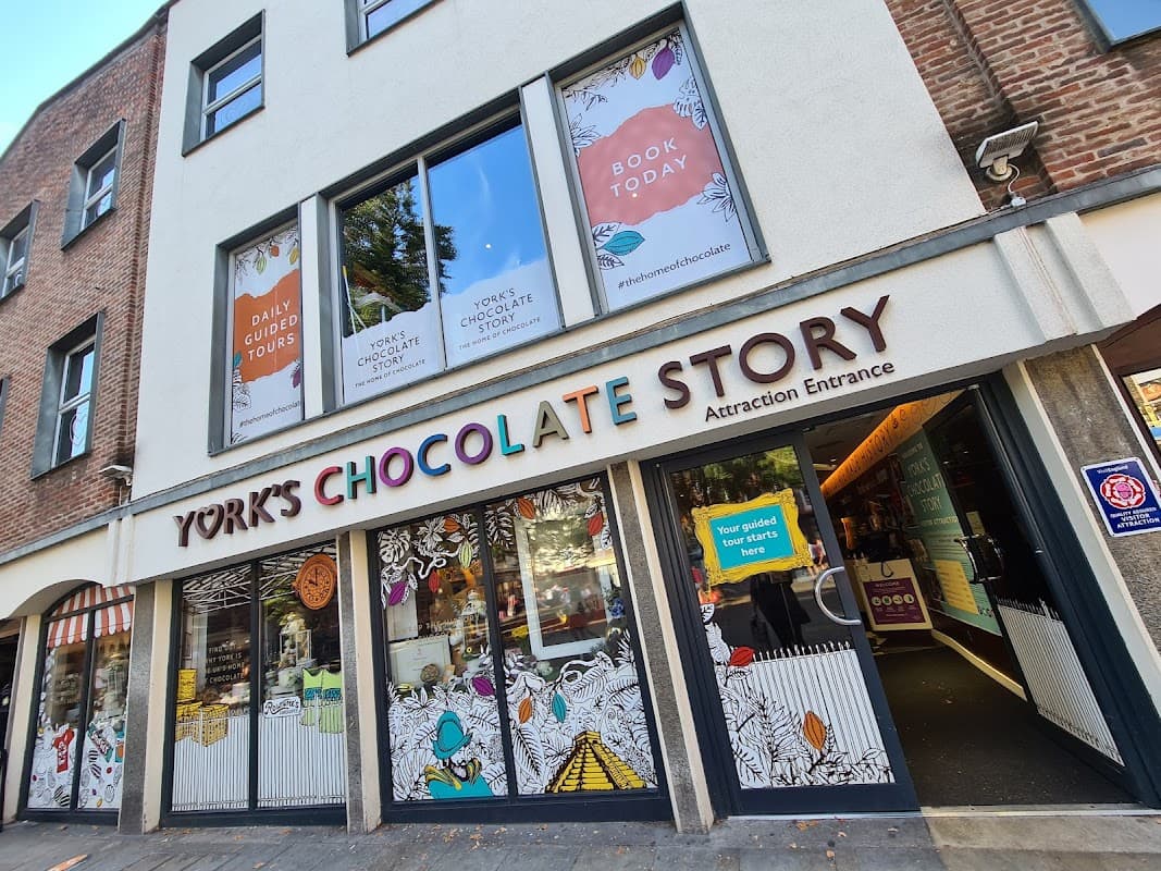 Colorful entrance of York's Chocolate Story with bold signage and window displays promoting tours and chocolate experiences.