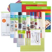 Cricut Everything Materials Bundle with vinyl rolls, colorful paper sheets, pens, cutting tools, and mats.