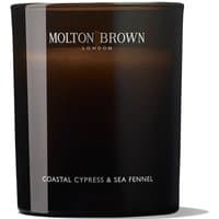 Black Molton Brown candle with white text, labeled "Coastal Cypress & Sea Fennel," in a sleek, glossy finish.