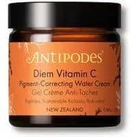 Amber jar of Antipodes Diem Vitamin C Water Cream with black lid and orange label featuring botanical design.