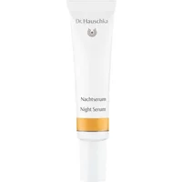 White Dr Hauschka Night Serum tube, 20ml, with gold band near base and brand logo on top.