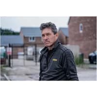 Gray and black Dewalt Jonesborough fleece jacket, zip-up style, with yellow logo on chest, worn by a person outdoors.