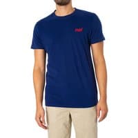 Blue Superdry Essential Logo T-Shirt with red logo on chest, short sleeves, crew neck, paired with beige pants.