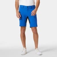Blue Helly Hansen men's deck shorts with belt loops, zip fly, and black side panels, worn by model with white shoes.