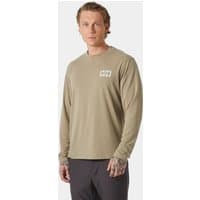 Beige Helly Hansen long sleeve tee, XL, with small chest graphic, worn by a model with dark pants.