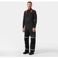 Black Helly Hansen Arctic Patrol Pants with suspenders, reflective stripes, and multiple pockets, size XS.