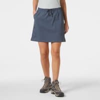 Blue Helly Hansen women's hiking skort with drawstring waist and side pockets, worn with hiking boots.