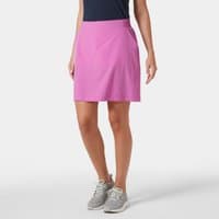 Pink Helly Hansen Thalia Skirt 2.0, women's XS, knee-length, with side pockets, worn with sneakers and a navy top.