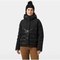 Black Helly Hansen women's down jacket with hood, chevron pattern, and front zipper, worn by a model.