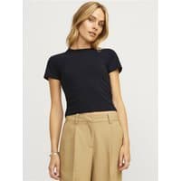 Black Jjxx Gigi Baby Tee, short sleeves, crew neck, fitted style, worn by model with beige pants.