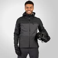 Men's black waterproof jacket with hood, zip closure, and logo on sleeve, worn by model holding a helmet.