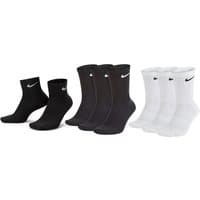 White Nike crew socks, cushioned, with black logo, part of a three-pack set.