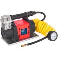 Red and black Sealey tyre inflator with silver cylinder, yellow coiled hose, and pressure gauge on black hose.