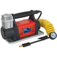 Red and black Sealey 12V tyre inflator with silver motor, yellow 7.5m hose, and attached pressure gauge.