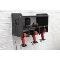 Black Sealey PTSR5 power tool storage rack with multiple slots, mounted on a white brick wall.