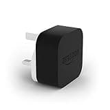 Black and white Amazon 9W USB charger with two-prong plug and embossed logo.