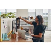 Black HP Poly Blackwire 3220 stereo headset with USB-C connector and USB-C/A adapter, worn by a person at a desk.