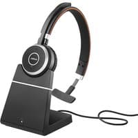 Black Jabra Evolve 65 SE mono headset with cushioned ear pad on sleek charging stand, featuring a boom microphone.