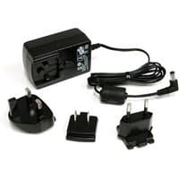 Black StarTech.com 12V DC 1.5A power adapter with interchangeable plug heads and coiled cable.