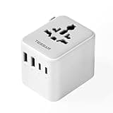 White TESSAN universal travel adapter with 2 USB C, 2 USB A ports, and multiple plug sockets for global use.