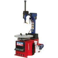 Red and blue Sealey TC10 automatic tyre changer with metal turntable and control panel, featuring safety labels.