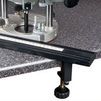Black and silver Trend Varijig tenon and grooving jig with adjustable guide rail on a workbench.
