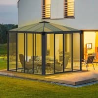 Grey 10x10 Palram Canopia Ledro 3000 gazebo with glass walls, pitched roof, and enclosed patio setting.