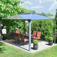 Gray aluminum garden gazebo with a polycarbonate roof, featuring an open design and surrounded by greenery.