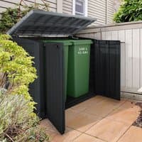 Black Keter plastic storage unit with open lid and doors, housing a green wheelie bin on a patio.