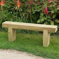 Wooden garden bench with rectangular seat and sturdy block legs, set on grass with vibrant flowers in the background.
