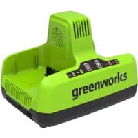 Green Greenworks 60V twin battery charger with dual slots, black base, and vented top.