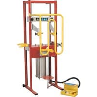 Red and yellow Sealey RE300 air-operated coil spring compressor with foot pedal and sturdy metal frame.