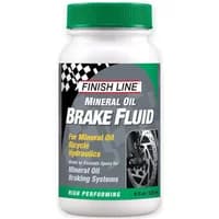 White bottle of Finish Line Mineral Oil Brake Fluid with green cap and black label featuring a bicycle wheel graphic.