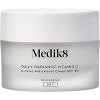White jar of Medik8 Daily Radiance Vitamin C cream, 50ml, with gray band and black text on the label.