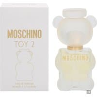 Clear teddy bear-shaped Moschino Toy 2 perfume bottle with gold lettering, next to matching white box.
