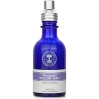 Blue glass bottle of Neal's Yard Remedies Goodnight Pillow Mist with silver spray cap and lavender label, 45ml.