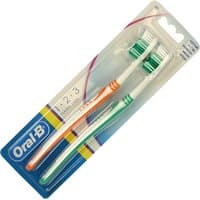 Two Oral-B 1-2-3 Classic Care toothbrushes, one orange and one green, in clear packaging.