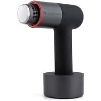 Black Sharper Image massager with cylindrical design, silver head, and red accents on a round base.