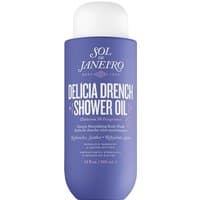 Purple Sol De Janeiro Delicia Drench Shower Oil bottle with white cap and bold white text.
