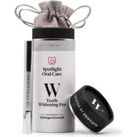Spotlight Oral Care Teeth Whitening Pen in silver tube with black cap, alongside cylindrical packaging and drawstring pouch.