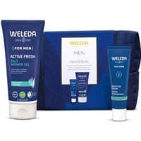 Weleda Mens Face & Body Gift Set with blue shower gel, moisturizer tube, and dark blue toiletry bag.