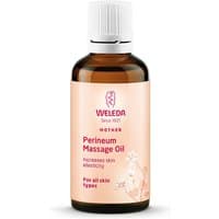 Brown glass bottle of Weleda Perineum Massage Oil, 50ml, with white cap and peach label featuring floral design.
