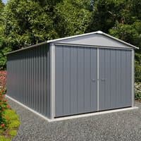 Gray metal garage by Yardmaster, 10' x 17', with double doors, pitched roof, and vertical panel design on gravel base.