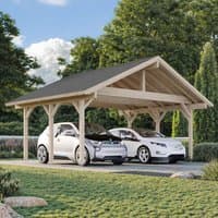 Wooden carport with pitched roof, natural finish, fits two cars, surrounded by greenery and trees.