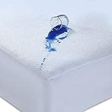 White waterproof mattress protector with terry top, extra deep 30cm stretch skirt, shown with water spill on surface.